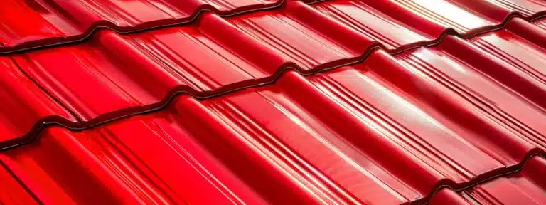 a vibrant red metal roof glistening under the bright florida sun, protected by a clear anti-rust coating.